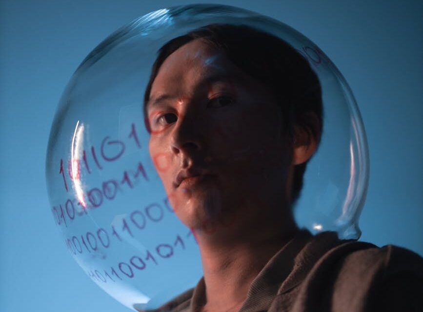 A humanoid robot touching a holographic interface displaying complex data charts, representing AI analysis.