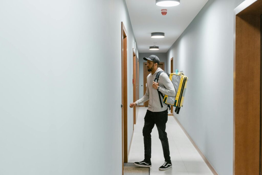 Close-up of hands carefully wrapping a handmade product in branded packaging for an Etsy customer.
