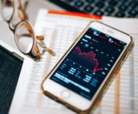 A humanoid AI robot analyzing complex sales data on a futuristic digital display, symbolizing AI in sales.