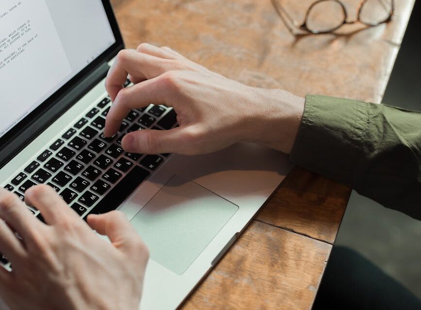 A freelancer typing on a laptop, with illuminated lines of code and data floating around the screen, representing AI assistance.