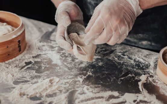 A neat row of glass meal prep containers filled with chicken, quinoa, and broccoli inside a refrigerator.