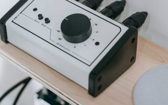 A professional home recording studio with a condenser microphone, pop filter, and audio interface.