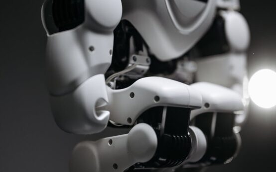 A sophisticated robotic arm precisely assembling a component on a clean, modern factory floor.