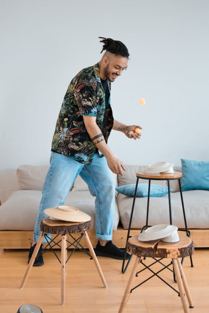 A person sits at a dinner table looking at an empty white plate with a clock beside it, symbolizing the fasting period of intermittent fasting.