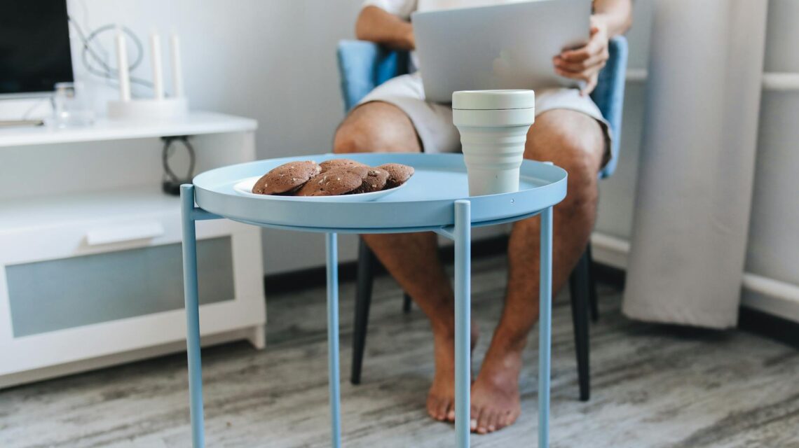 A person focused on their laptop, working from a comfortable home desk, ready to make money testing websites.