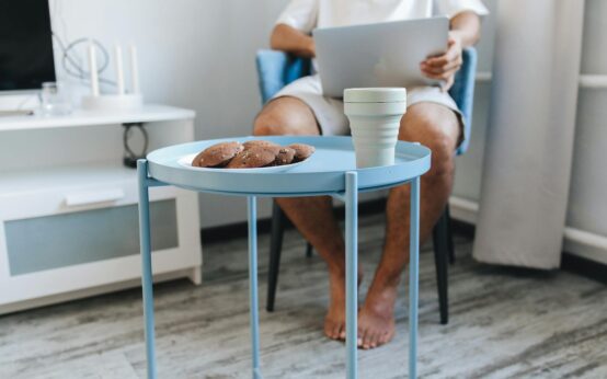 A person focused on their laptop, working from a comfortable home desk, ready to make money testing websites.
