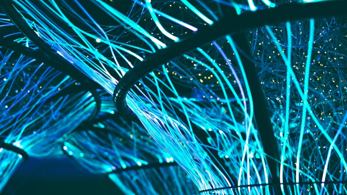 Abstract visualization of a glowing blue and purple neural network representing artificial intelligence.