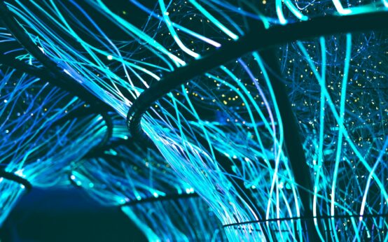 Abstract visualization of a glowing blue and purple neural network representing artificial intelligence.