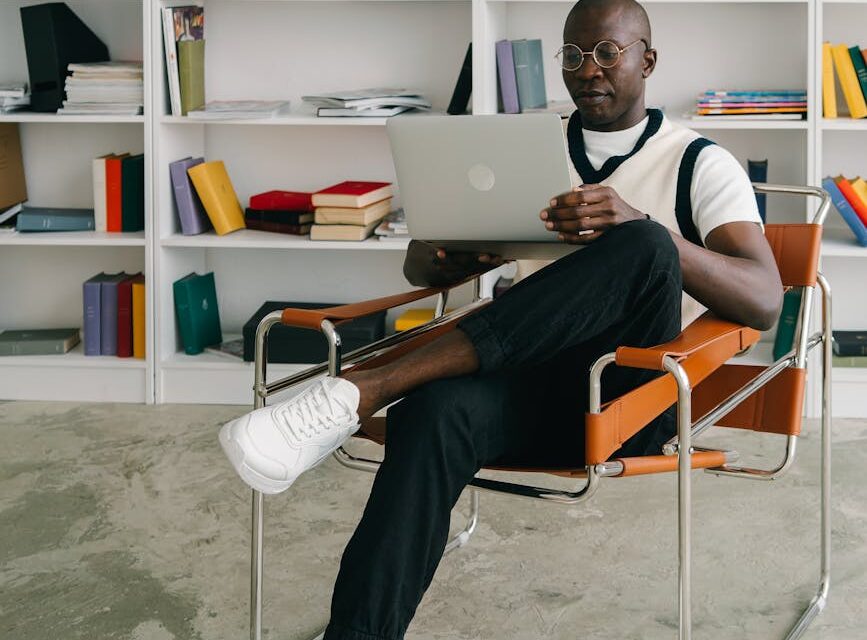 A young student smiles while interacting with a holographic display on a futuristic tablet for a personalized learning experience.