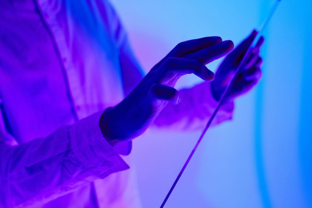 A user's hands manipulating a holographic user interface that displays complex data visualizations, showcasing an AI-powered application.