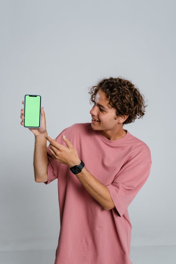 A happy woman looking at her computer screen, showing her credit card to represent her earnings from online surveys.
