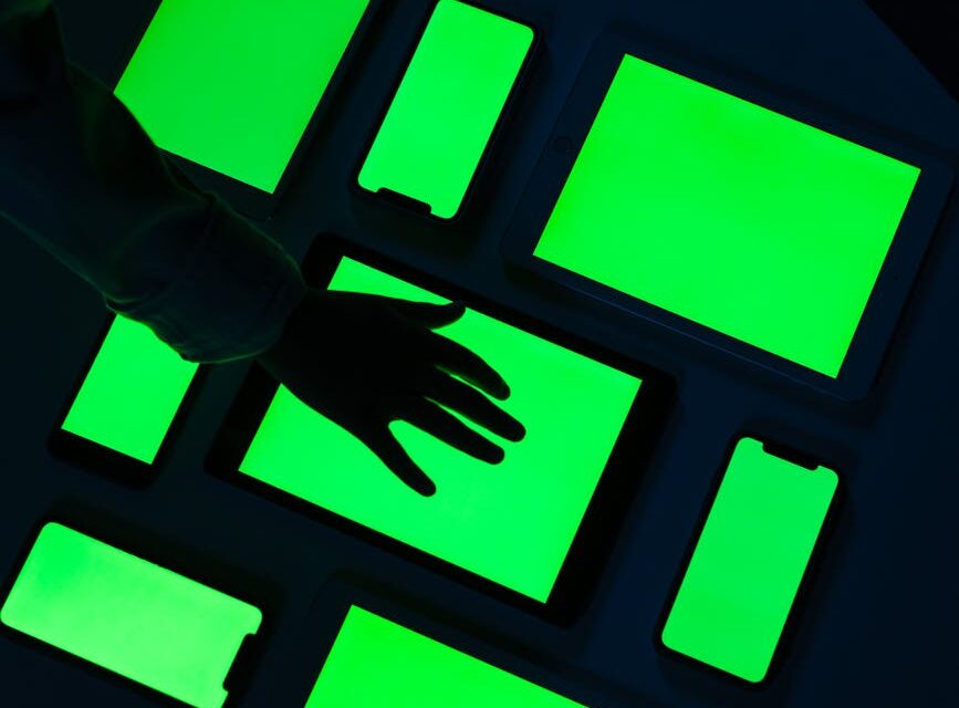 A close-up of a human finger interacting with a holographic display showing complex data and AI analytics.