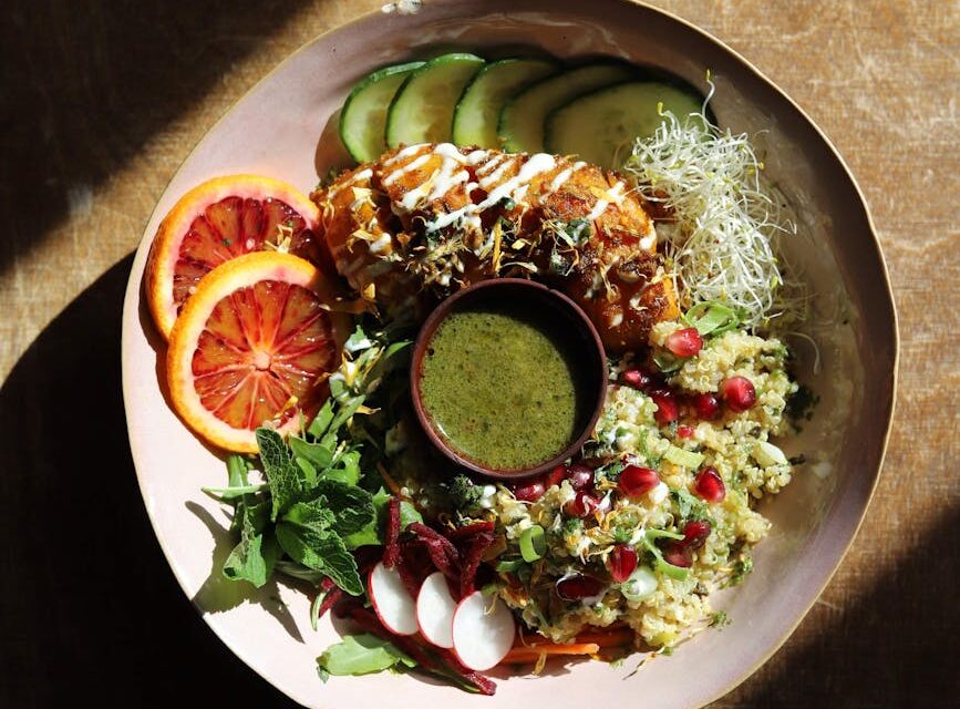 A vibrant and healthy plate of food featuring salmon, quinoa, and a variety of colorful vegetables, representing a brain-healthy meal.