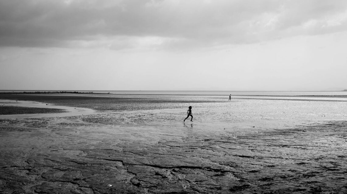 A founder stands on a cliff overlooking a vast, calm blue ocean, symbolizing uncontested market space.