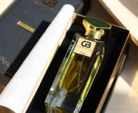 A close-up of a person's hands holding a cereal box and reading the nutrition facts and ingredients list.