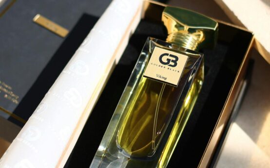 A close-up of a person's hands holding a cereal box and reading the nutrition facts and ingredients list.