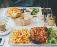 A traveler mindfully enjoying a croissant and coffee at a charming Parisian sidewalk cafe.