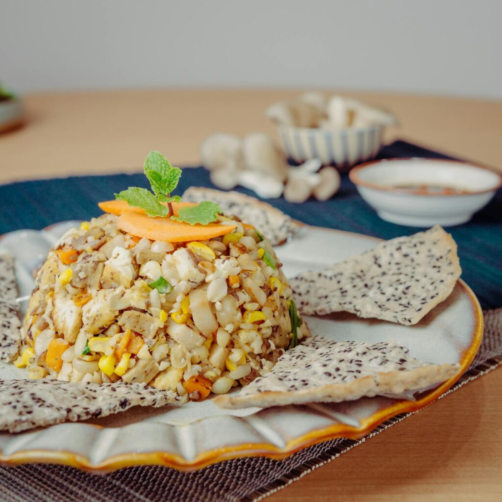 A vibrant and healthy quinoa salad bowl filled with fresh greens, cherry tomatoes, cucumber, and bell peppers.