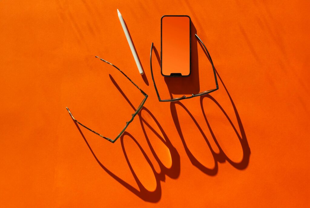 A customer seamlessly shopping online using a smartphone, a tablet, and a laptop, demonstrating an omnichannel experience.