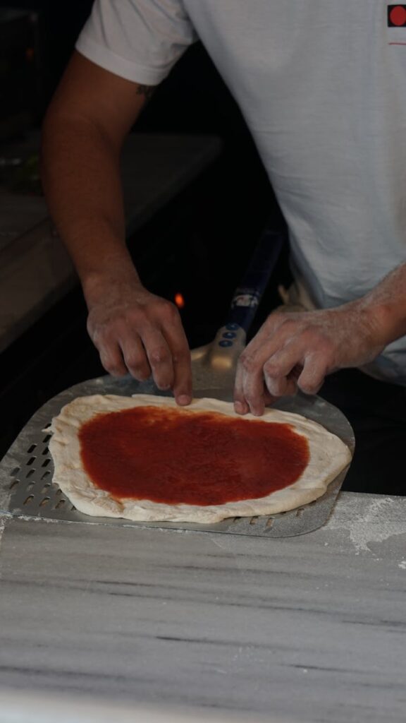 A professional chef meticulously plating a dish, highlighting the importance of safe food preparation.