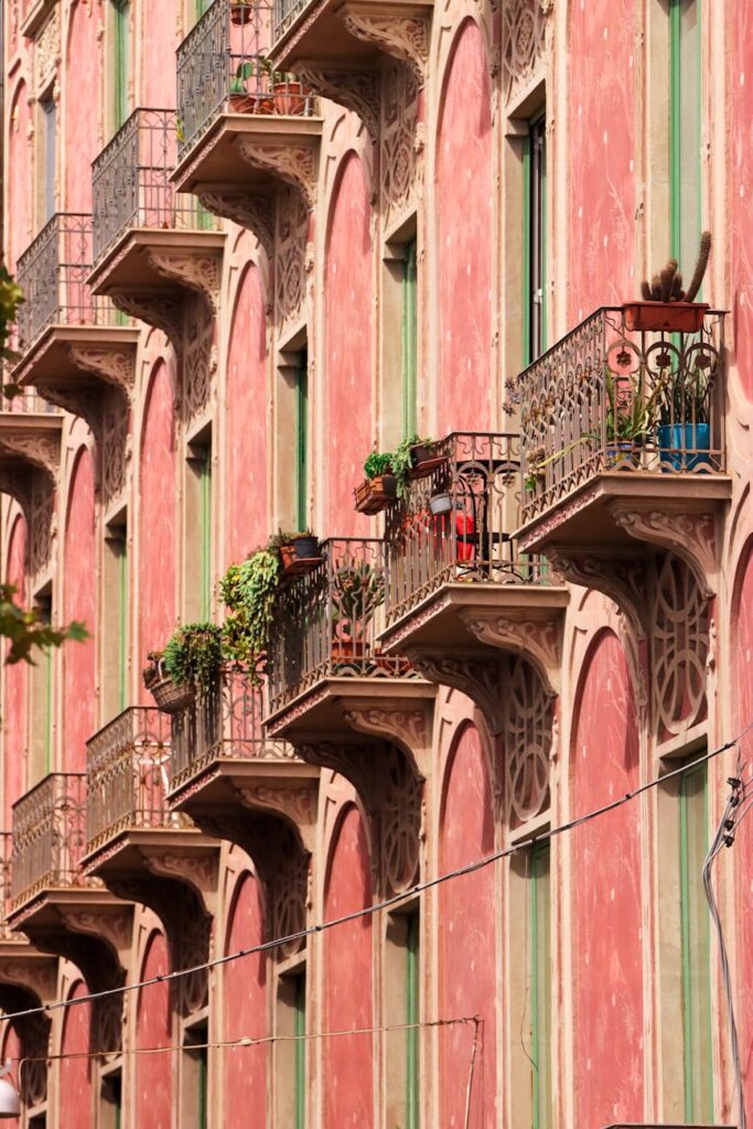 Sunlight illuminates the intricate facade of a historic building in a classic European city square.