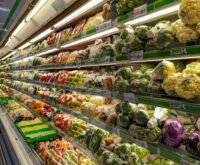 A grocery store aisle stacked high with colorful boxes and packages of processed foods.