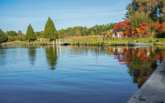A solitary gondola navigating a narrow Venetian canal shrouded in ethereal morning fog.