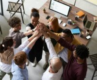 Close-up of two business professionals in suits shaking hands firmly.