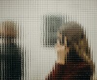 A business professional subtly shaking their head 'no' during a boardroom meeting.