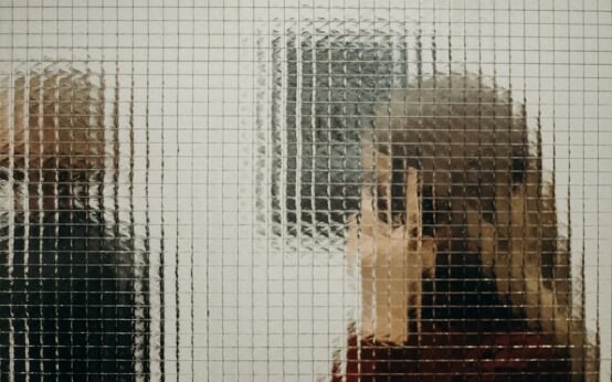 A business professional subtly shaking their head 'no' during a boardroom meeting.