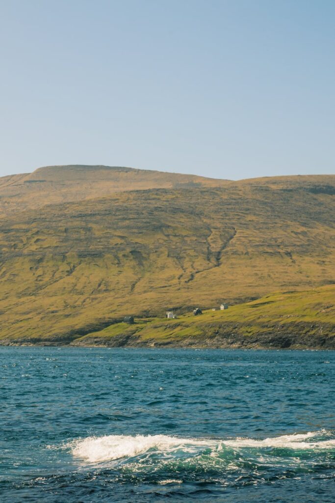 The distinctive Tindhólmur sea stack rising from the ocean near Vágar in the Faroe Islands.