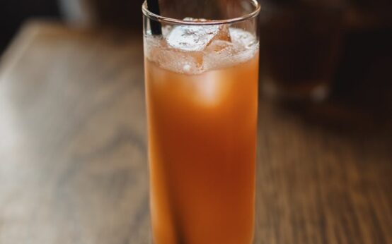A traveler sits alone, thoughtfully sipping from a traditional Japanese teacup in a serene tea house in Kyoto.