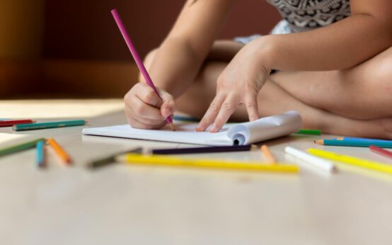 A marketing strategist brainstorming content repurposing ideas on a large whiteboard.