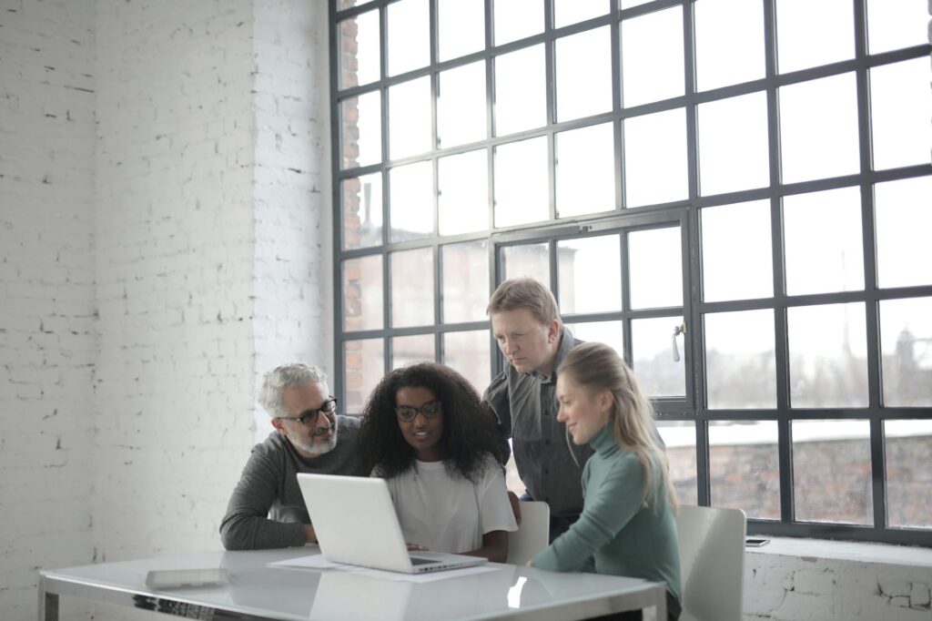 A finance team and an operations manager collaborating over a table with documents.
