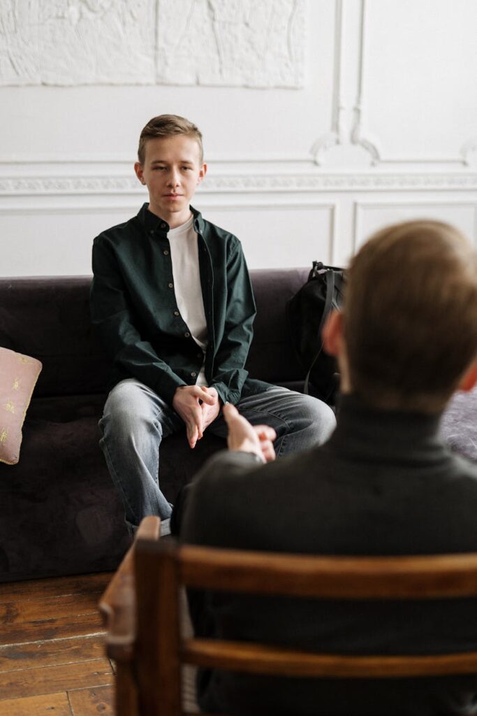 A compassionate doctor discusses test results with a concerned patient in a bright and modern clinic office.