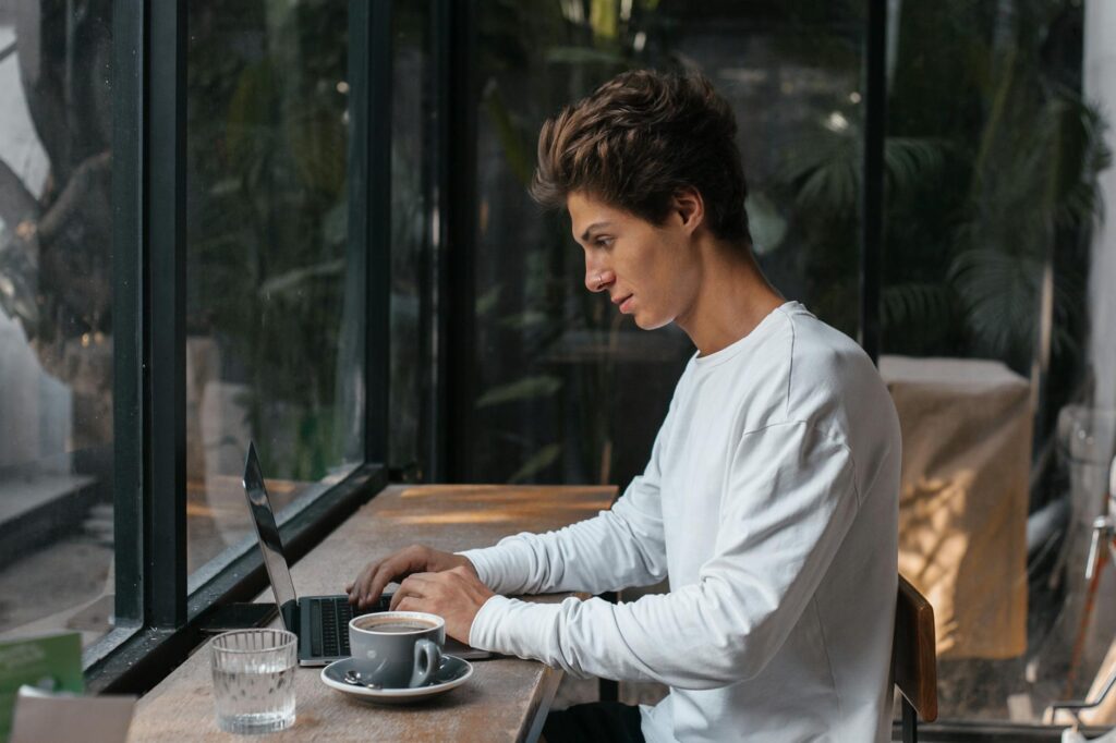 A freelancer working on a laptop with a scenic outdoor background, illustrating the flexibility of remote jobs.