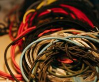 An abstract digital representation of a quantum computing network with glowing nodes and interconnected lines.