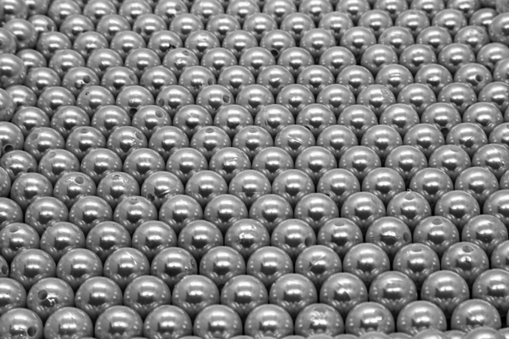 A chain reaction of toppling dominoes, representing the cascading effects of a supply chain disruption.