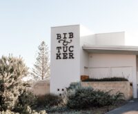 A sunlit, minimalist hotel lobby with clean lines and a neutral color palette.