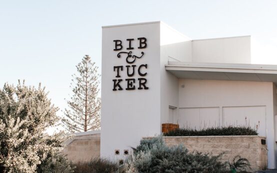 A sunlit, minimalist hotel lobby with clean lines and a neutral color palette.