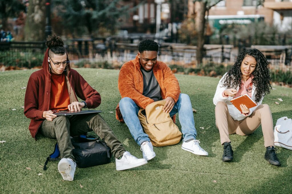 A diverse group of college students collaborating on a project around a library table.