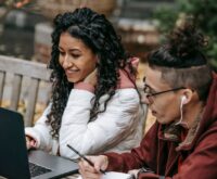 A young college student speaking into a professional microphone for their podcast.