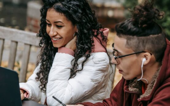 A young college student speaking into a professional microphone for their podcast.