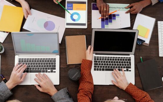 A student focused on their laptop which displays a rising financial graph, symbolizing online income.