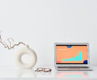 A data scientist with glasses analyzing complex data visualizations on a large monitor in a modern office.