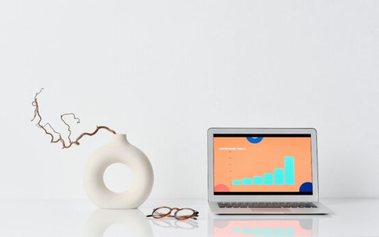 A data scientist with glasses analyzing complex data visualizations on a large monitor in a modern office.