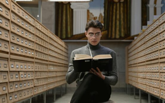 A diverse group of students collaborating around a table in a bright, modern library.