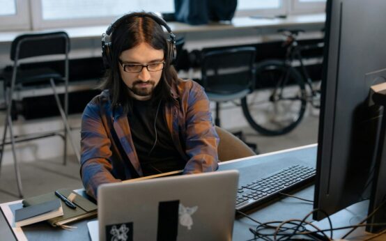 A developer working on a complex headless commerce architecture with code on multiple monitors.