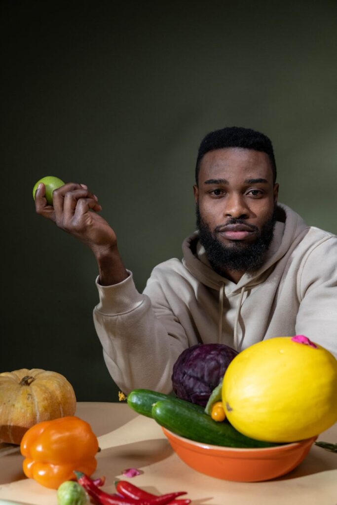 A vibrant overhead shot of various fresh produce, including bell peppers, broccoli, and berries, symbolizing whole foods.