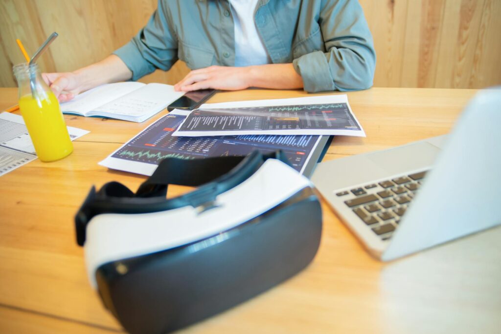 Close-up of a manager's hands writing a detailed performance improvement plan document on a clipboard.